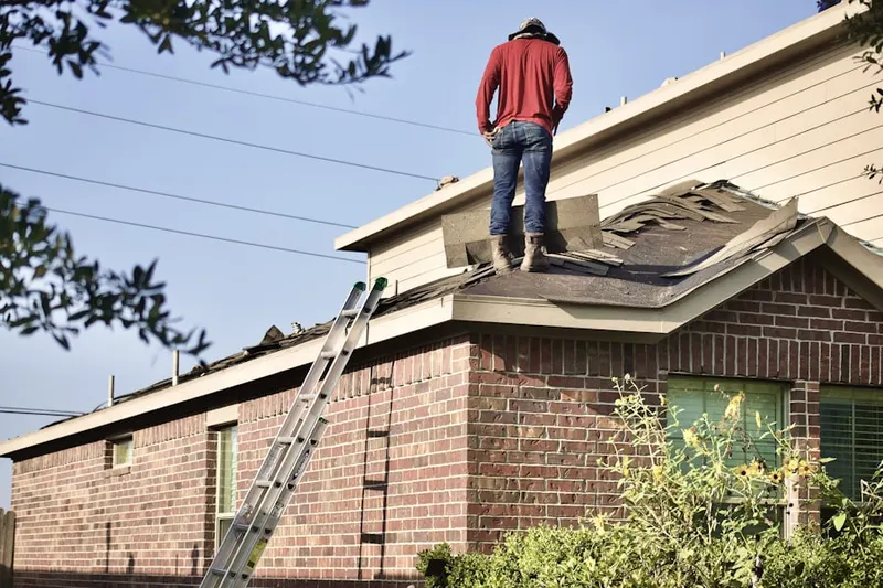 Professional roofer working on a residential roof in Whispering Hills
